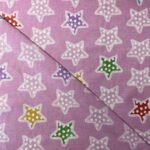 Toile de coton Étoile multicolore, fond rose