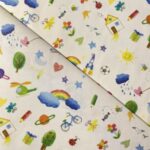 Tissu coton imprimé Bio Certifié GOTS Dessins enfant - Multicolore, fond blanc
